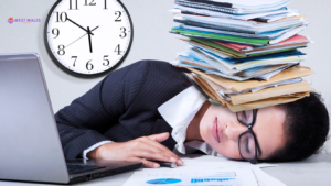 A tired expat professional in a suit, resting on a desk with a stack of documents balanced on their head.