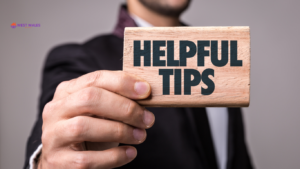 A man holding a plaque saying helpful Tips