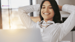 Smiling woman relaxing at her desk, representing the success and peace of mind achieved with a buy-to-let mortgage investment