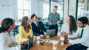 A professional business meeting in a modern office, showcasing a leader presenting to a diverse team, highlighting the importance of workplace mortgage advice and collaboration