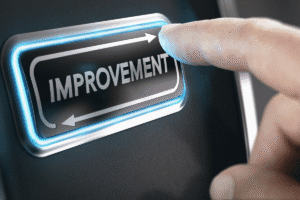 Finger pressing the 'Improvement' button, symbolising the opportunity to improve Interest Coverage Ratio (ICR) and overcome buy-to-let mortgage challenges