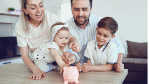 Smiling family saving money together at home, symbolising the importance of mortgage protection for long-term financial security.