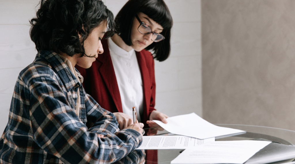 Professional adviser reviewing income protection documents with client during financial consultation