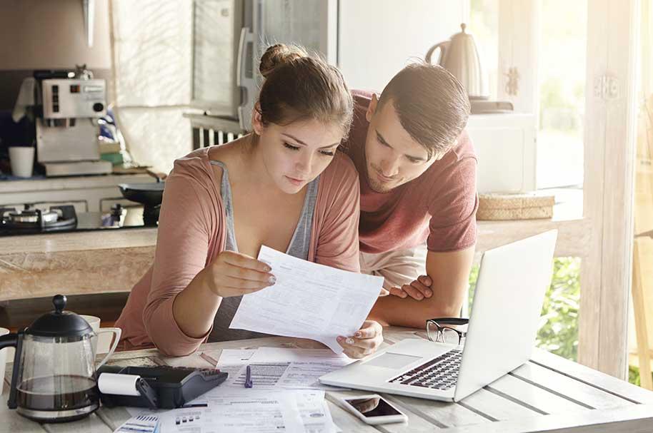 First-Time Buyers Reviewing Mortgage Affordability And Household Finances