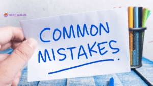 A hand holding a piece of paper with ‘COMMON MISTAKES’ written in blue marker, with a blurred background