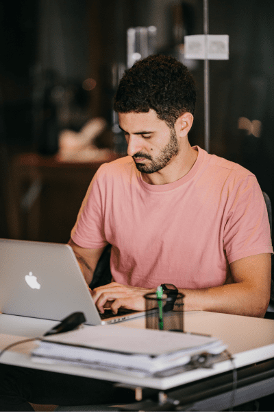 Focused mortgage broker working on a laptop, providing personalised buy-to-let mortgage solutions.