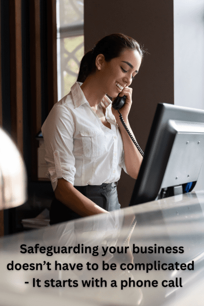 Professional woman on a phone call at her desk, captioned 'Safeguarding your business doesn’t have to be complicated – It starts with a phone call,' representing accessible business protection guidance in four simple steps