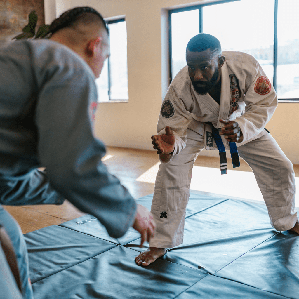Two martial artists practising jiu-jitsu, showcasing the need for sports injury insurance to protect active lifestyles and high-intensity training