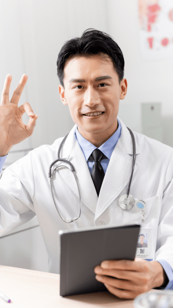 Hospital specialist in a white coat smiling confidently while holding a tablet, symbolising professional care and expertise