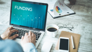 Laptop screen displaying the word ‘Funding’ representing financial options for landlords to meet new EPC rules and property upgrade costs.