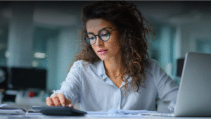 A company director checking digital financial records and using bookkeeping software to stay MTD-compliant.