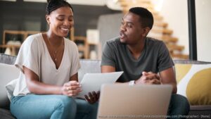 Couple reviewing mortgage documents at home while discussing life insurance protection