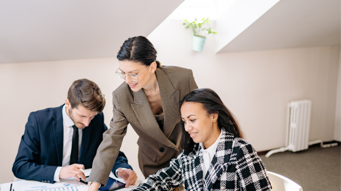 Company directors reviewing financial reports and discussing business protection planning in a boardroom meeting