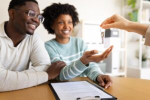 Couple receiving house keys after securing a mortgage Decision in Principle