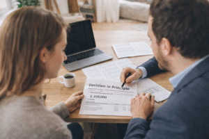 Couple reviewing a Mortgage Agreement in Principle document showing estimated borrowing amount