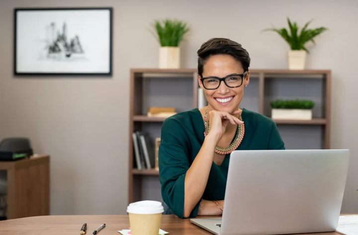 Company director reviewing finances on laptop planning mortgage borrowing strategy