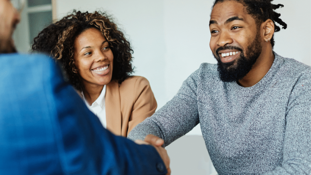 Couple receiving professional advice and agreeing interest-only mortgage plan with advisor