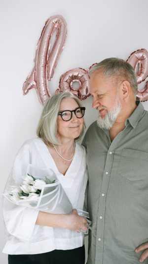 Couple aged 55+ celebrating later-life financial security and homeownership