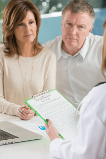 Couple over 55’s sitting with a mortgage broker
